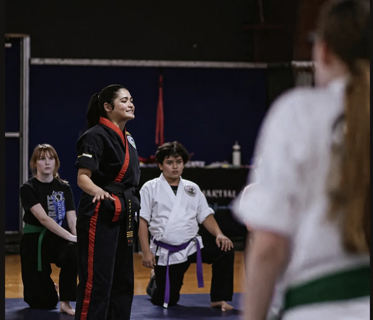 An instructor sharing a laugh with students during class